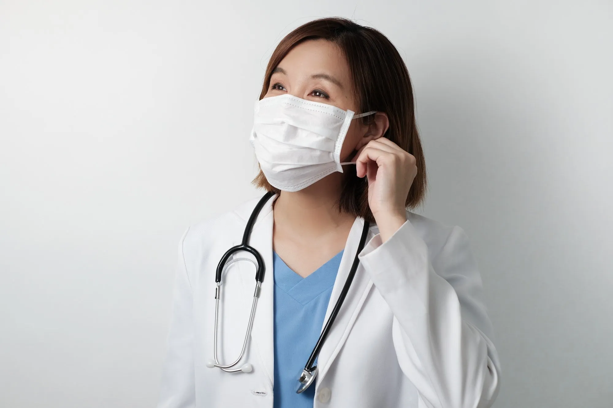 Moon Adult Health — healthcare professional putting on protective mask